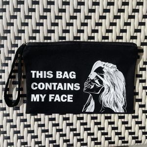 This Bag Contains My Face Black Skeleton Wristlet
